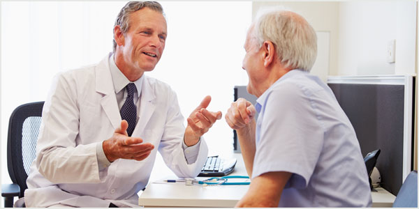 Old man talking with doctor