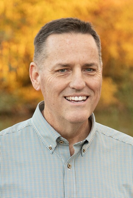 smiling confidently in professional attire a medicare insurance az agent, Dallin Read